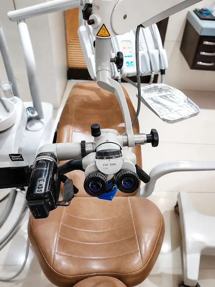 Close-up of the Carl Zeiss dental microscope's optical eyepieces mounted chairside in clinical working position at My Dentist Kakadeo Kanpur
