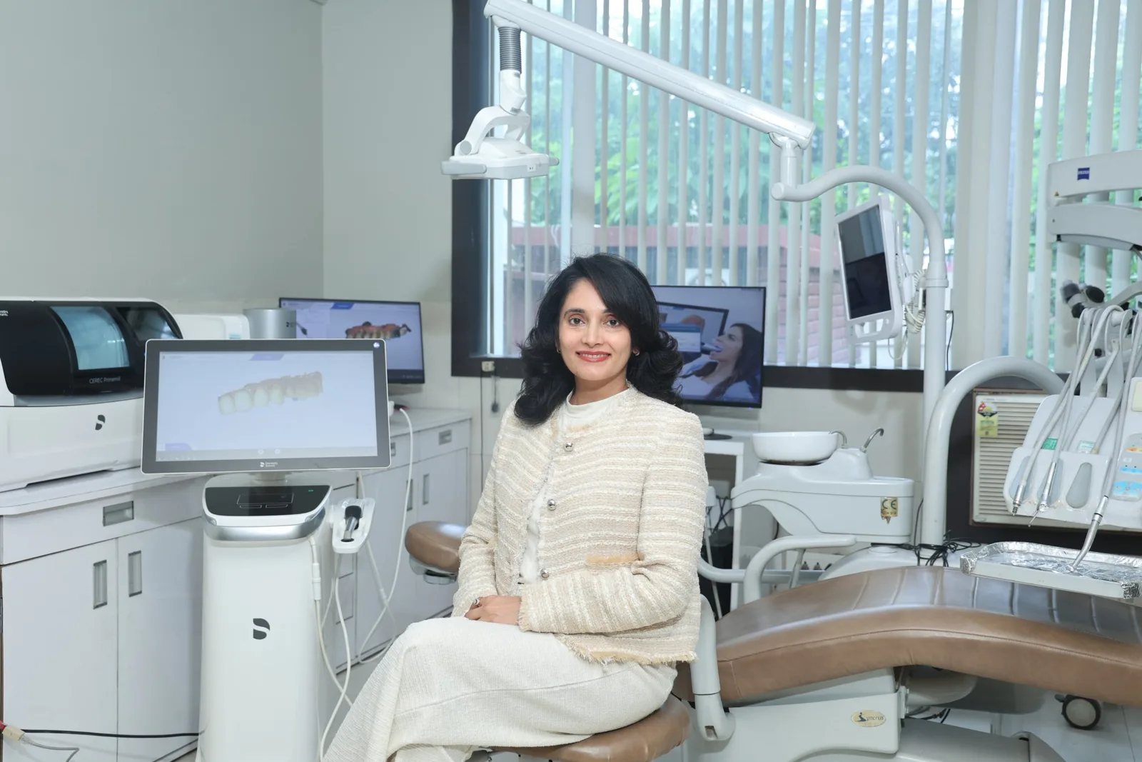 Dentist seated in a treatment room with CEREC Primemill and digital scanner at Dr Sawhney's My Dentist, dental clinic in Kakadeo, Kanpur